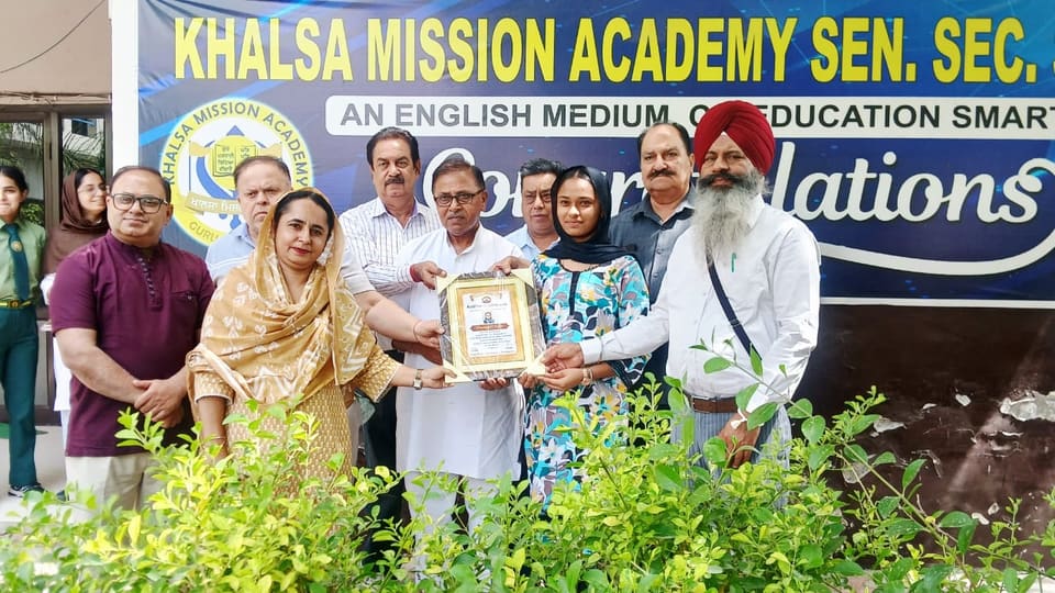 Guests presenting a framed memento to school representatives