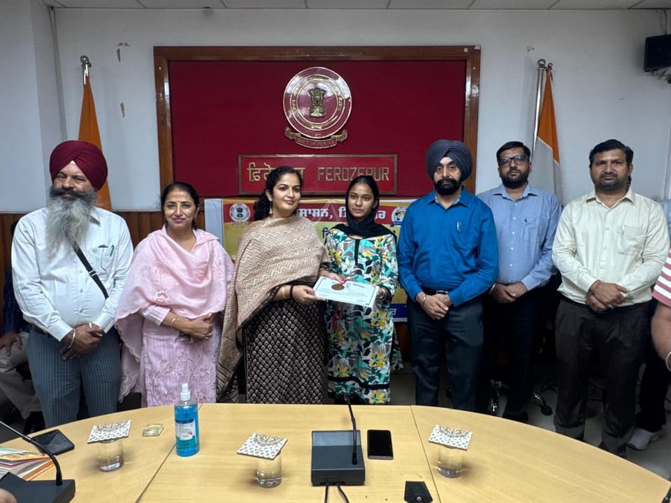 Teachers receiving a certificate at the district office