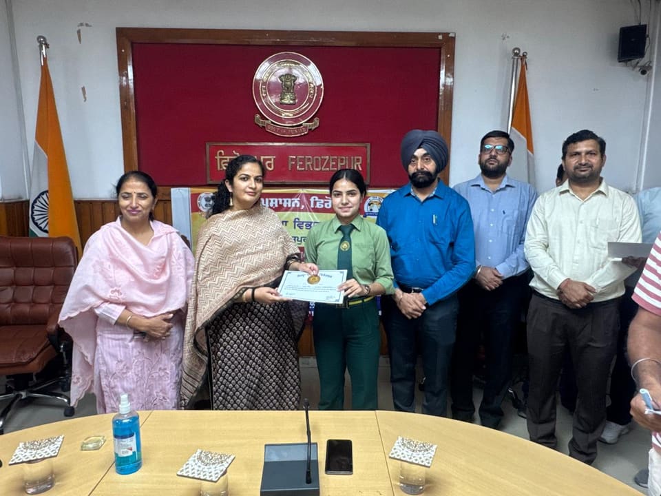 Staff members holding a certificate at the district office