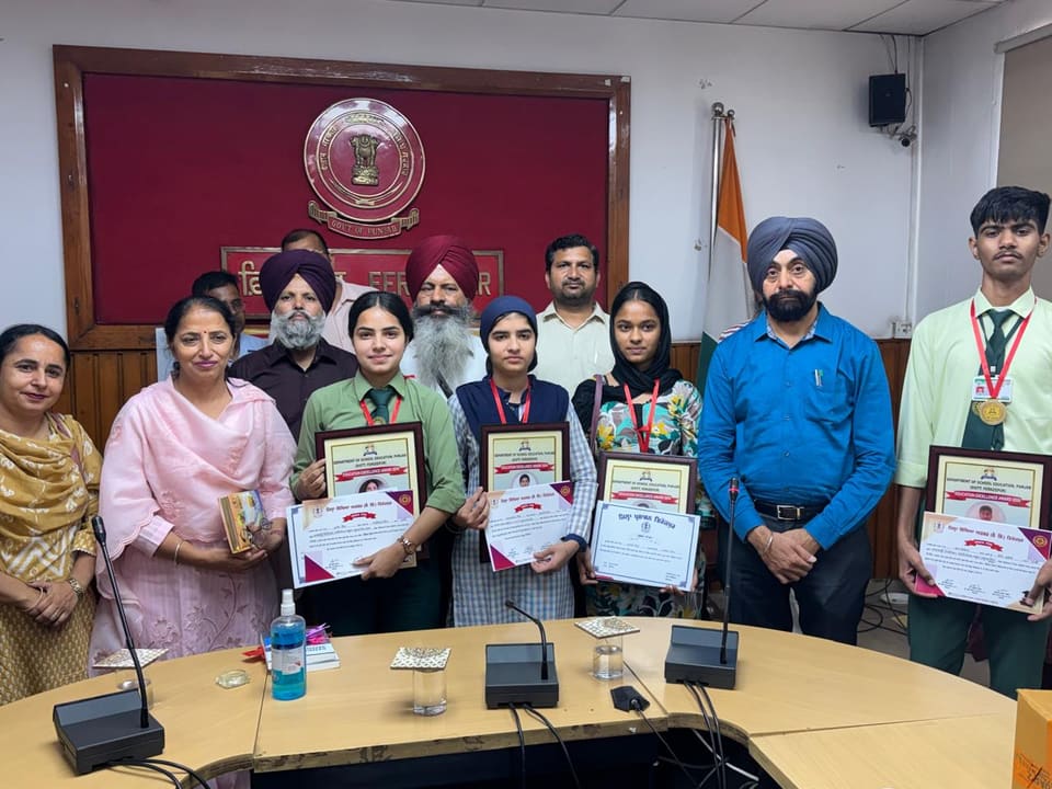 Students with medals and certificates alongside their teachers