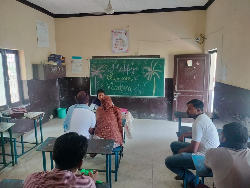 Classroom gathering with a Happy Summer Vacation message on the board