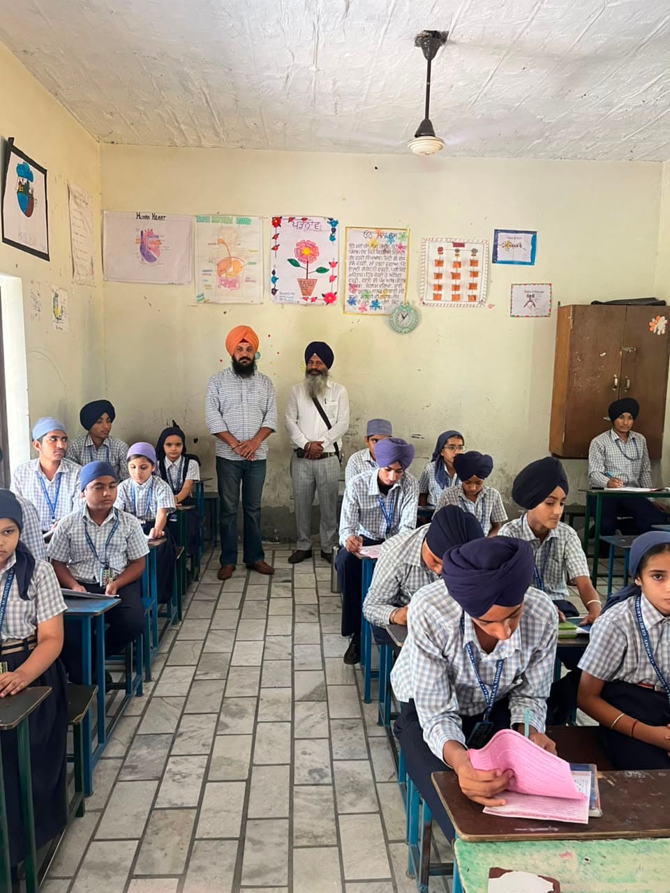 Rows of students working quietly at classroom desks