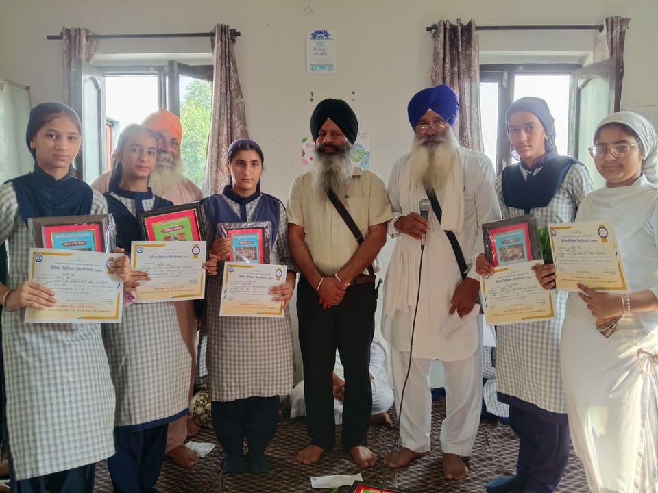Students displaying certificates won at a Gurmat competition