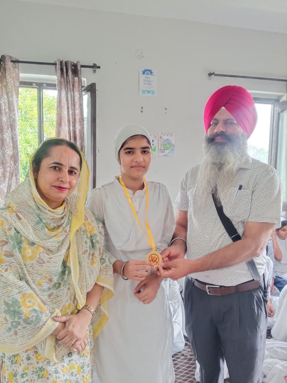 A student being awarded a medal by teachers and family