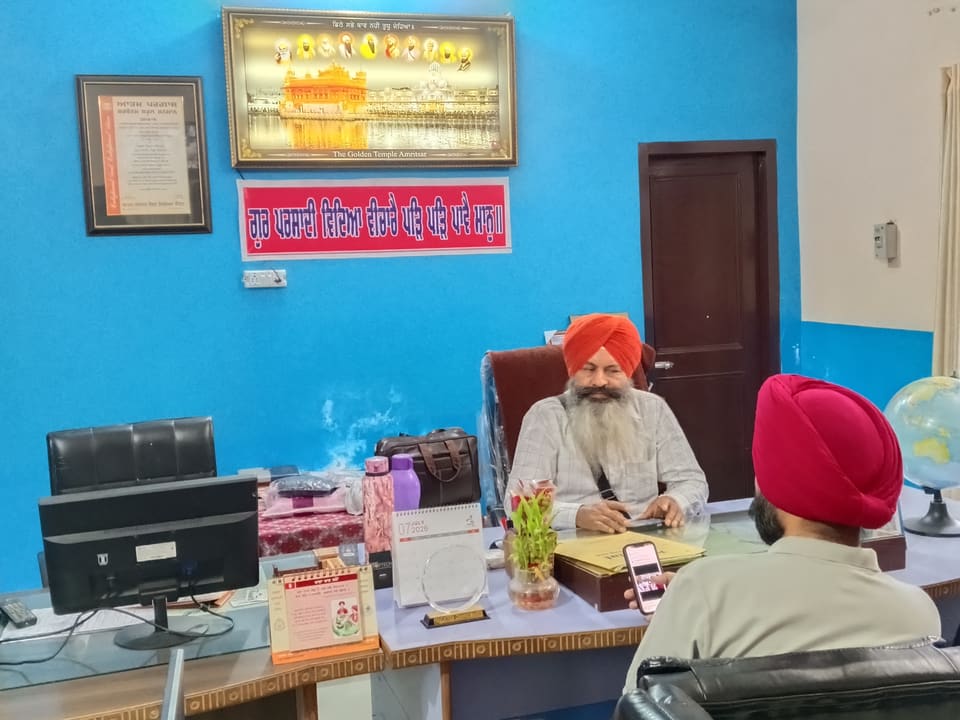 The school office with framed Gurbani verses on the wall