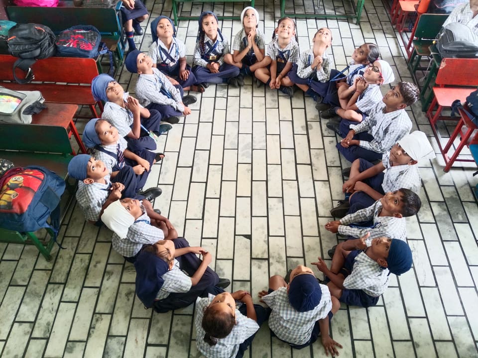 Children arranged in a circle formation during a group activity