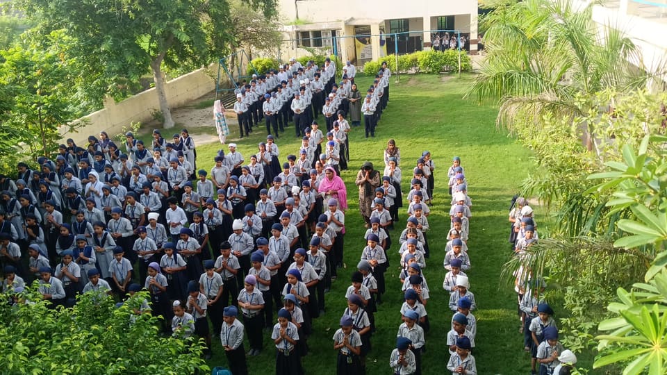 The whole school lined up in rows on the lawn for morning assembly
