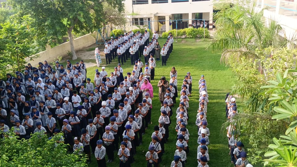 Raised view of students assembled in formation on the school grounds