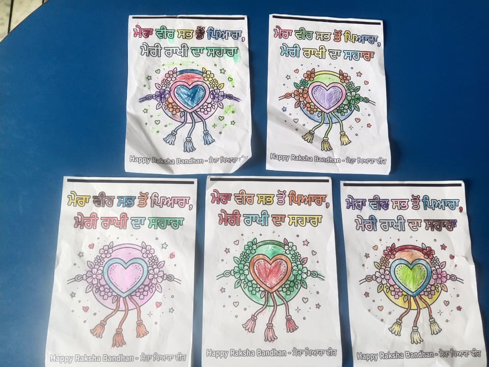 Five coloured Rakhi posters pinned to the classroom display board