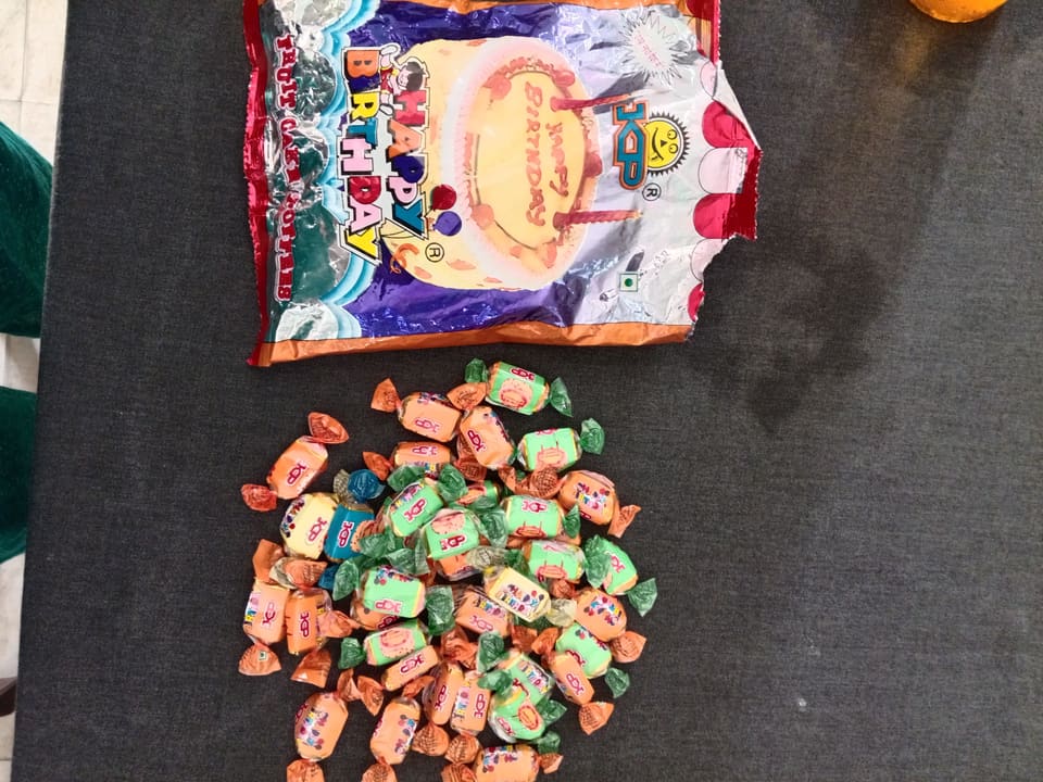 A birthday cake and toffees laid out for the class to share