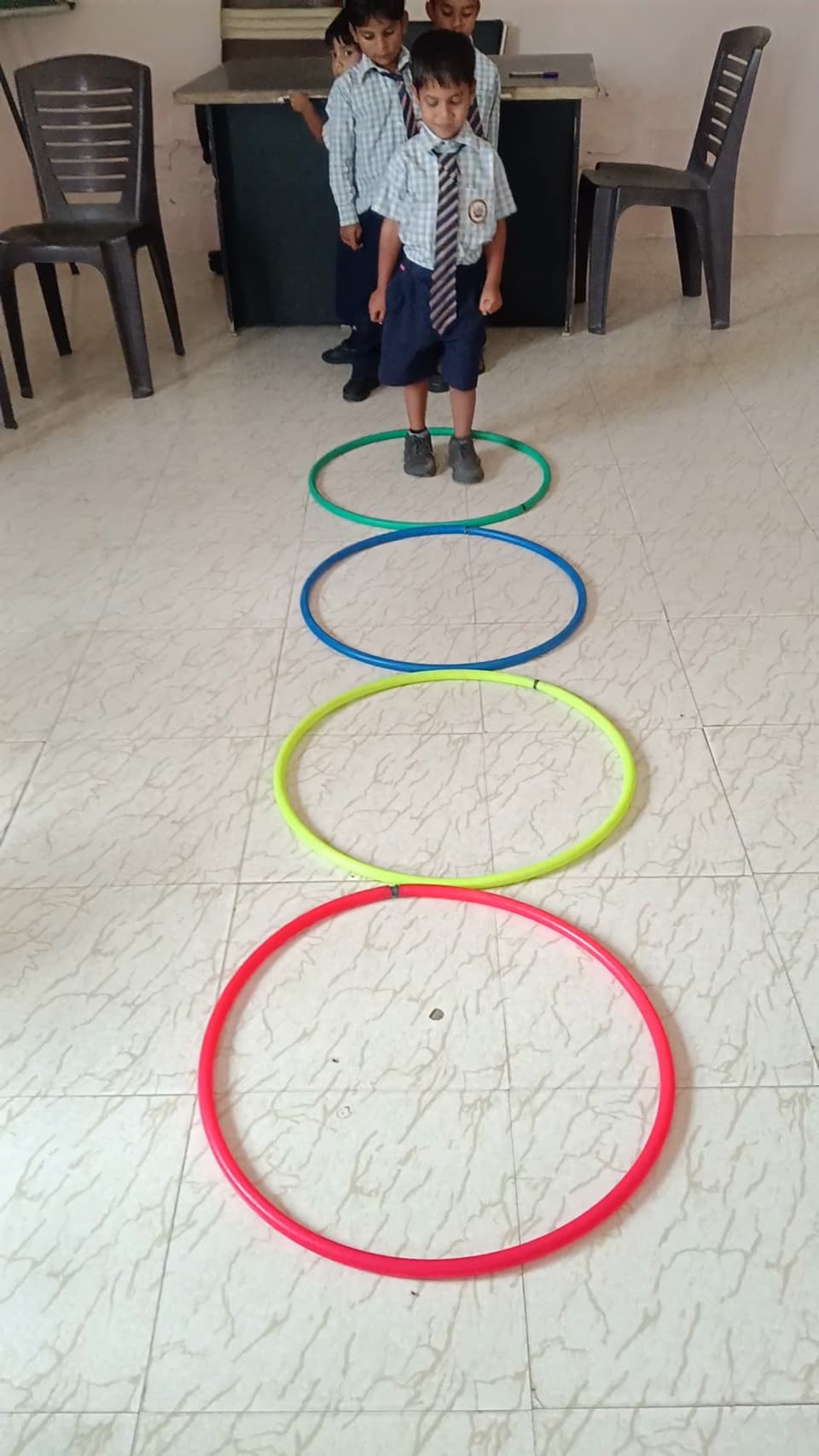 Coloured rings laid out on the floor for a primary group game