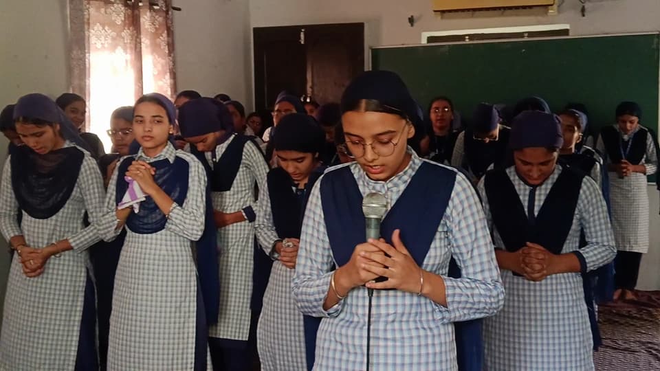 Senior students standing together in prayer