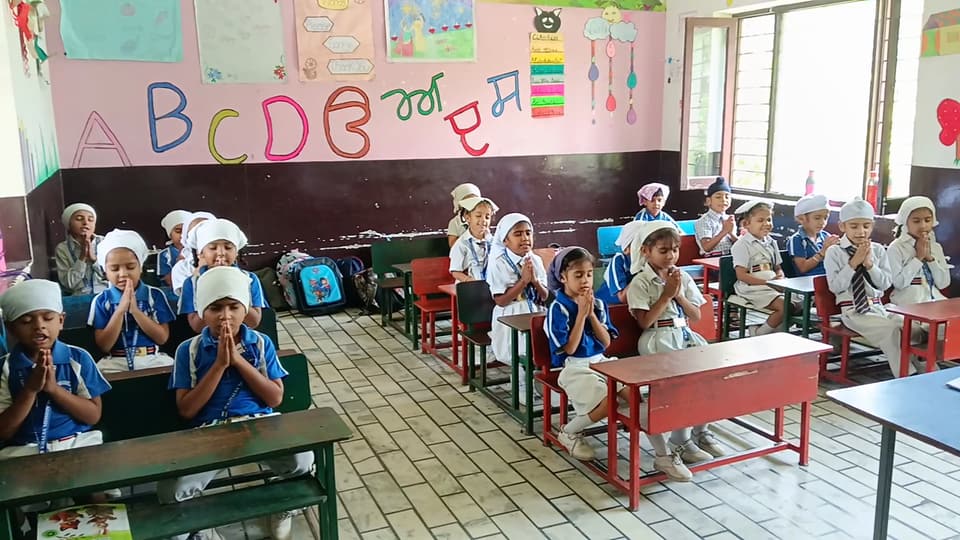 Primary classroom decorated with English and Punjabi alphabet charts