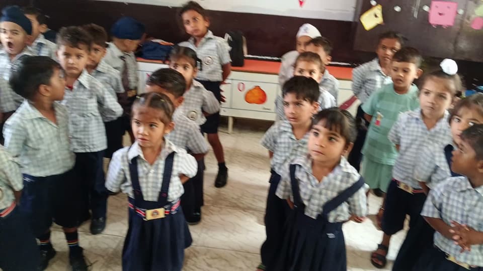 Primary students doing an action song together in class