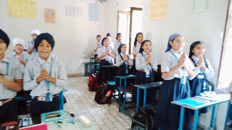 Students clapping and singing in their classroom
