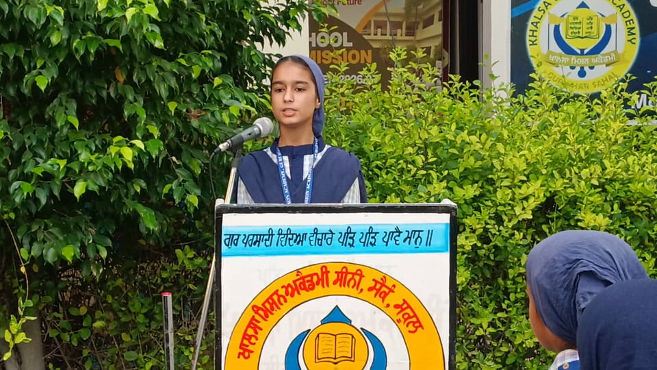A student addressing the assembly from the school lectern