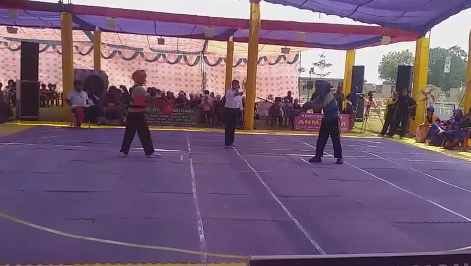 A Gatka performance on a mat before a seated audience